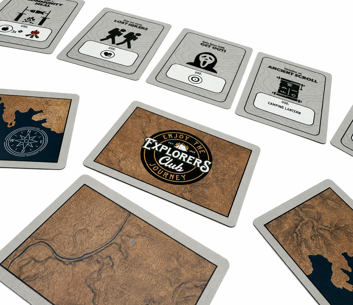 Explorers Club map cards and action cards arranged on a table.